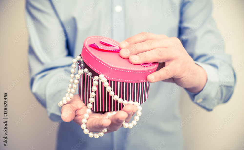 man holding a gift box in the form of heart 