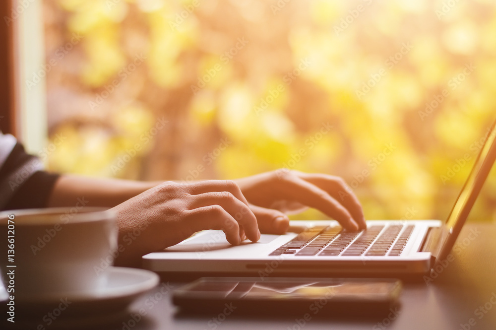 Close up shot of business womans hands typing on laptop.