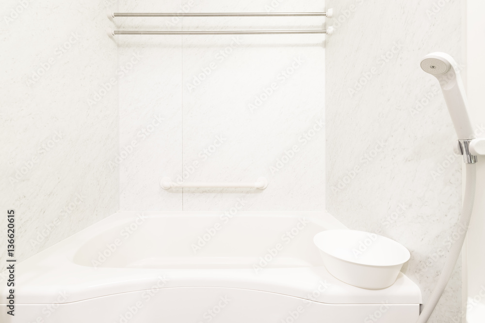 White bathtub and shower at clean bathroom