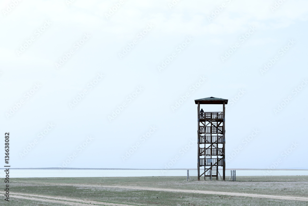 Alone observant tower and silhouette of man