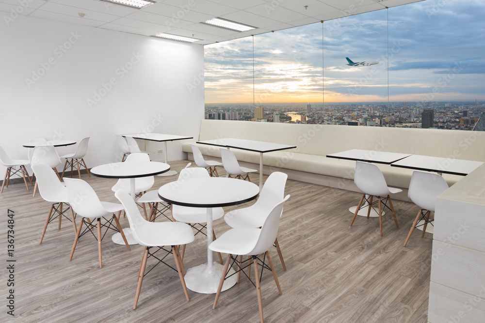 White wooden chairs in dining room with city view