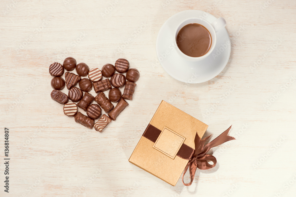 Valentine background with chocolate truffles and coffee cup.