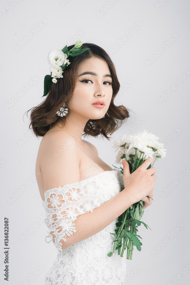 Beautiful asian woman bride on grey background.