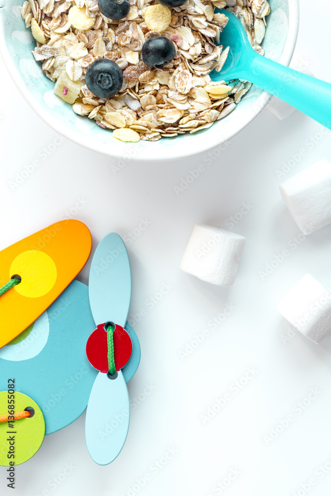 concept kid breakfast with muesli top view on white background