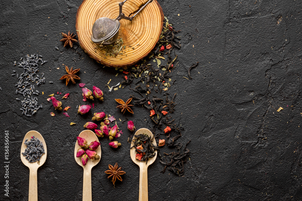 Herbs on spoons black background mockup top view