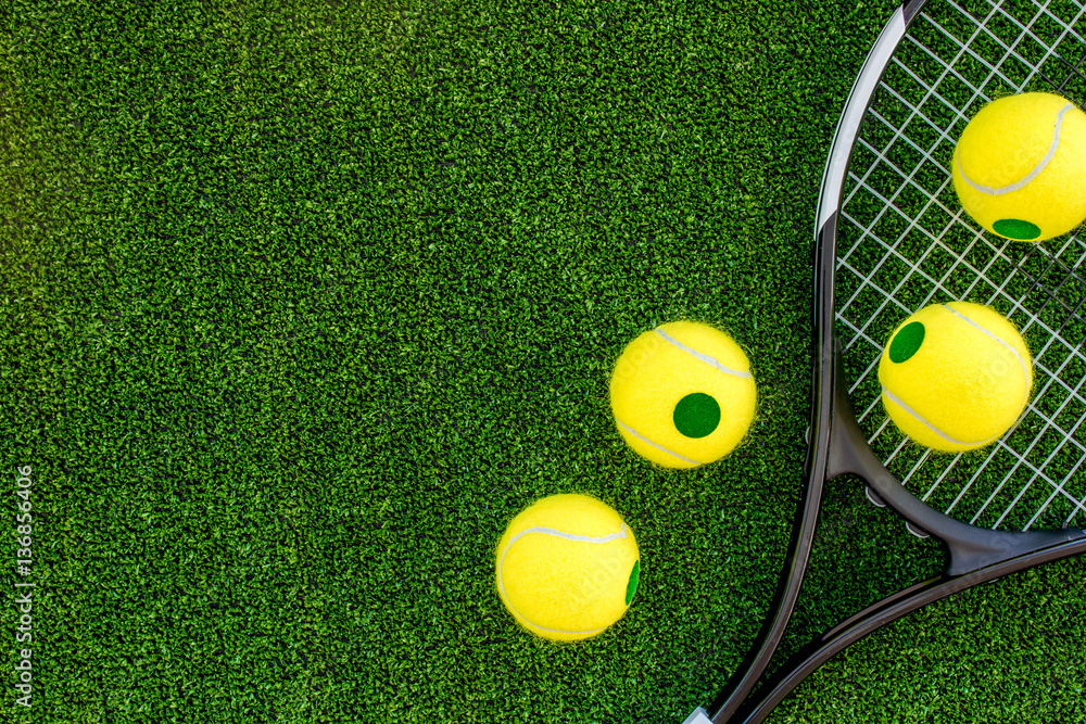 tennis racket on green background top view