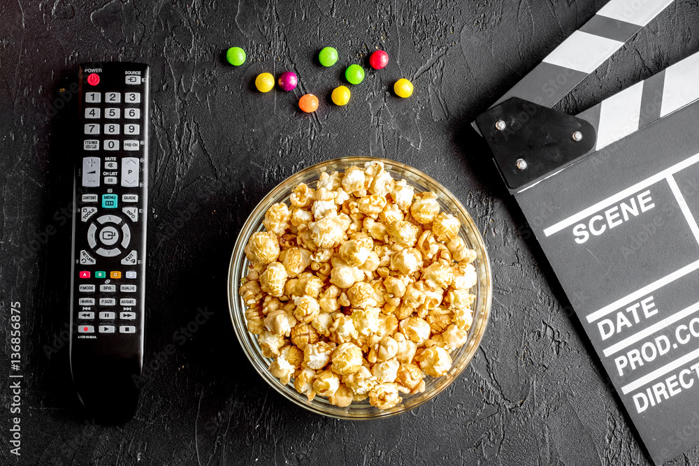 concept of watching movies with popcorn top view dark background