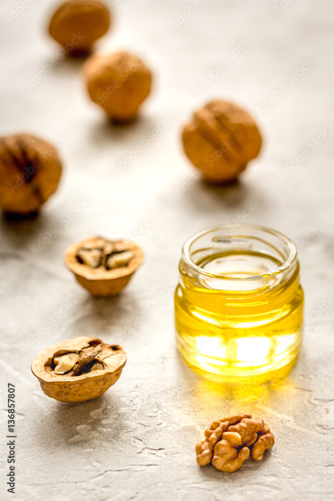 cosmetic and therapeutic walnut oil on gray background