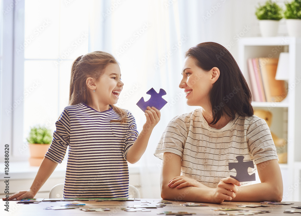 Mother and daughter do puzzles