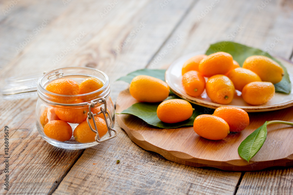 kumquat on plate at wooden table