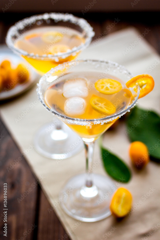 cocktail with kumquat on wooden background