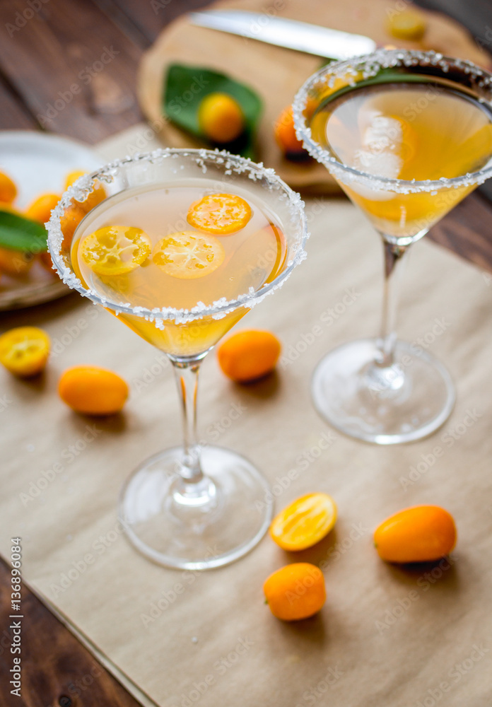 cocktail with kumquat on wooden background