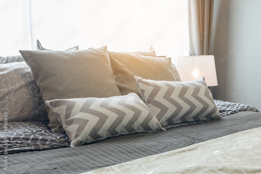 set of pillows on bed in cozy bedroom