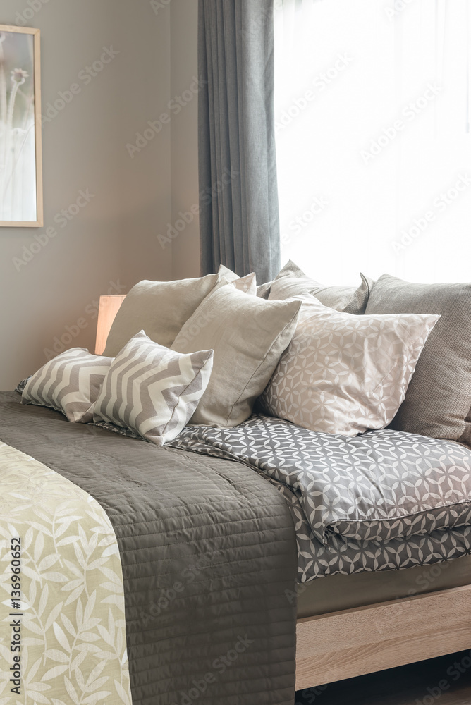 set of pillows on bed in cozy bedroom