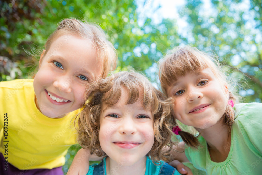 Group of happy children playing outdoors