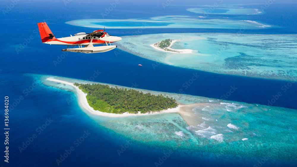 Sea plane flying above Maldives islands