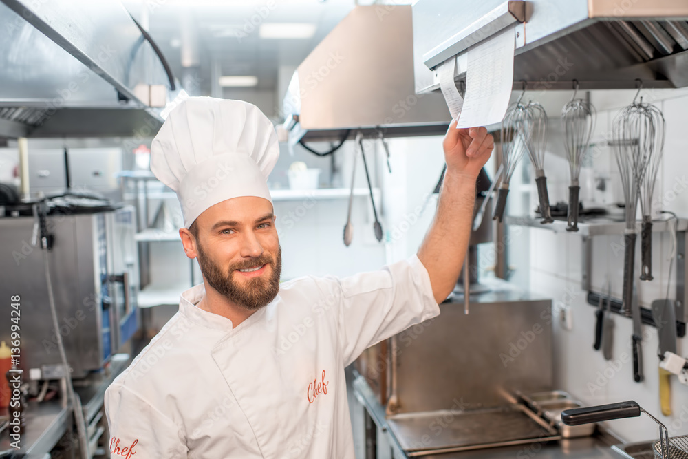 Chef cook checking the order at the restaurant kitchen