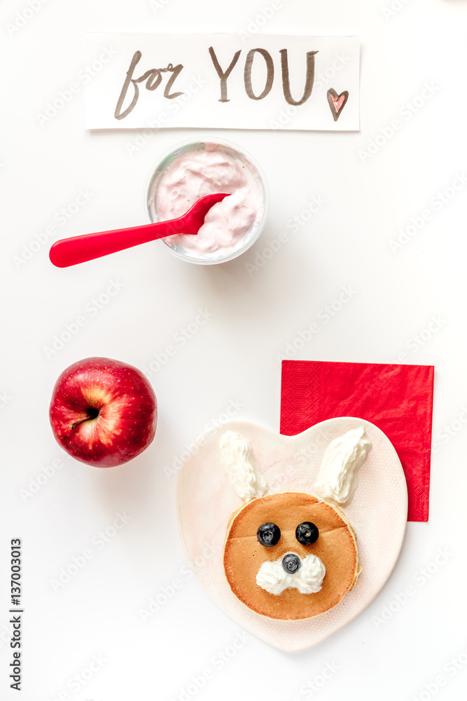 concept kid breakfast with pancake top view on white background