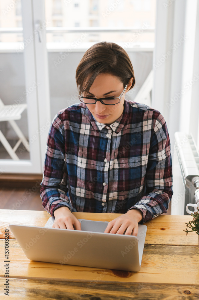 Young beautiful girl with a laptop at home