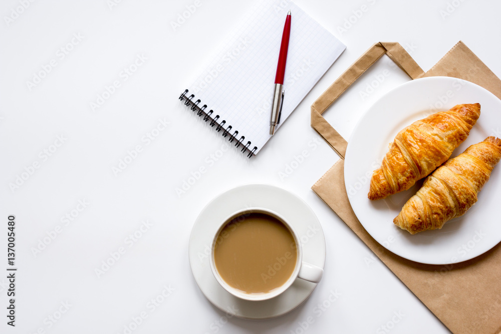 Business lunch with croissant on white table top view