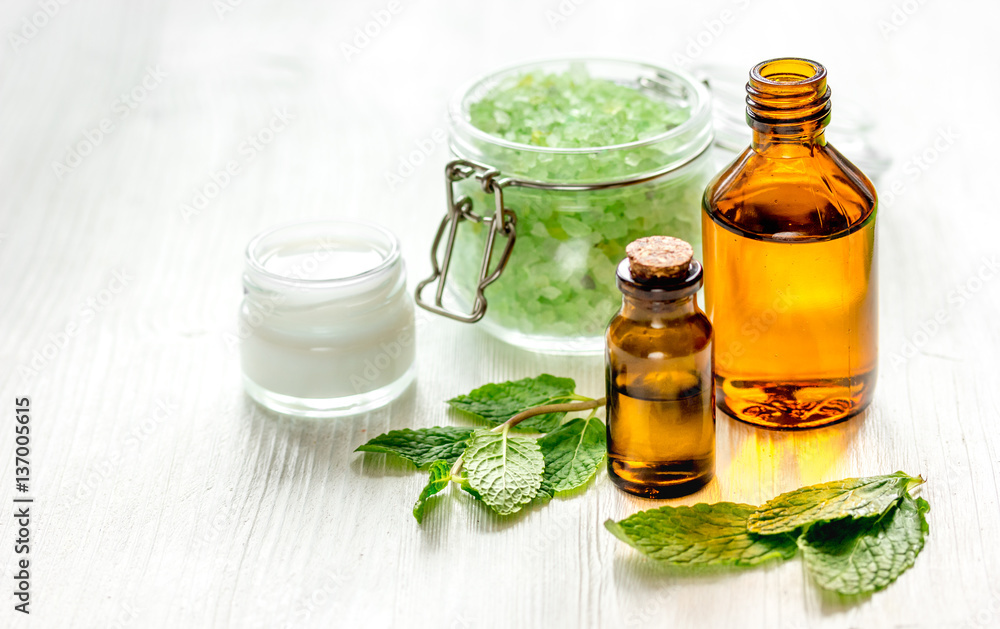 organic cosmetics with herbal extracts of mint on wooden background