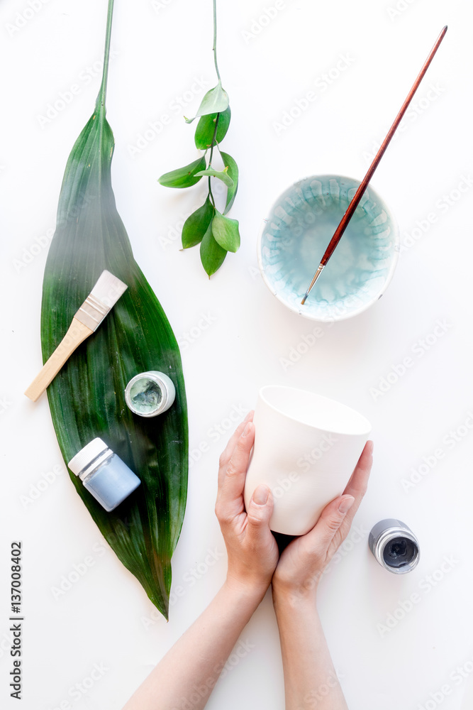 painted ceramic cup on white background top view