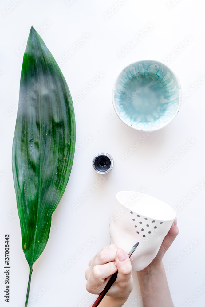 painted ceramic cup on white background top view