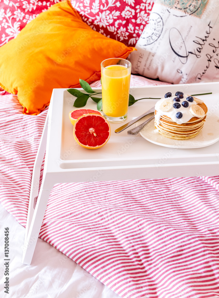 breakfast in bed on tray with juice