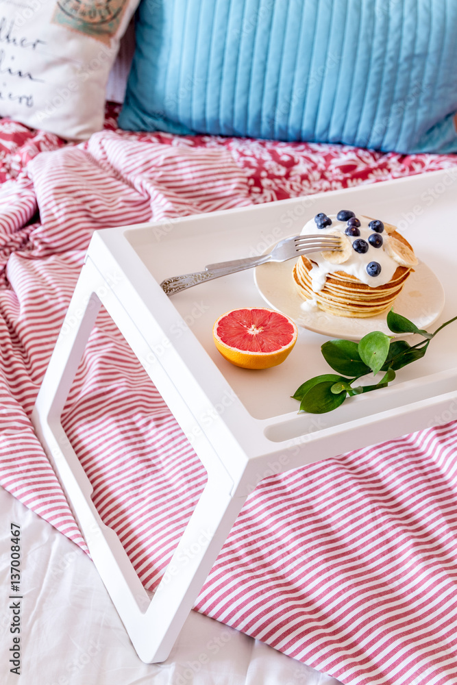 breakfast in bed on tray with juice