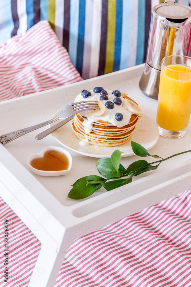 breakfast in bed on tray with juice