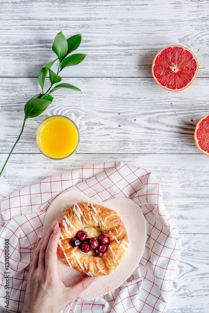 Breakfast concept with flowers on wooden background top view