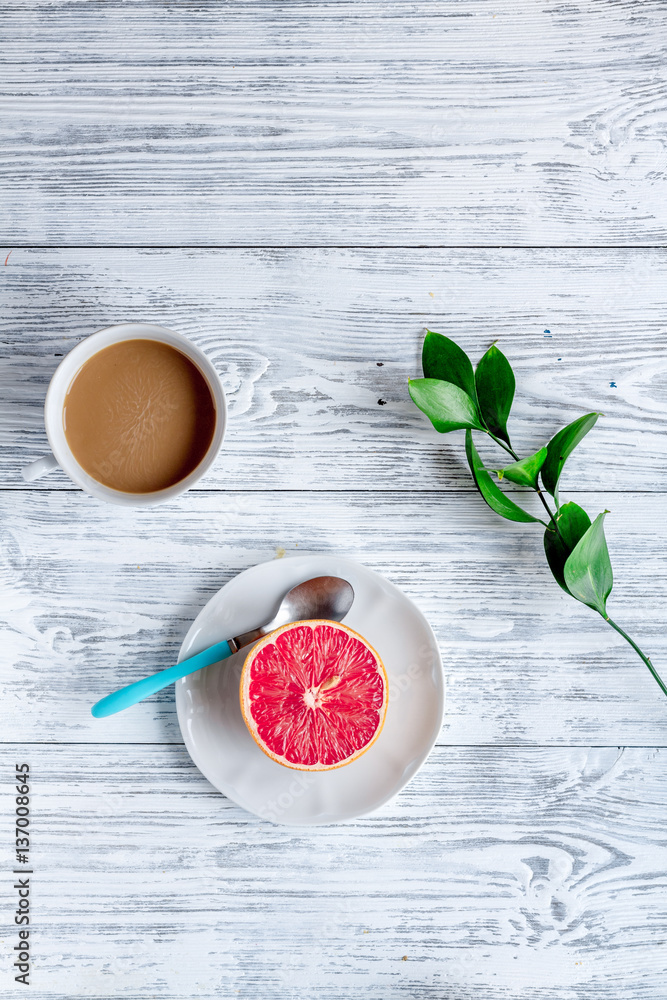 Breakfast concept with flowers on wooden background top view