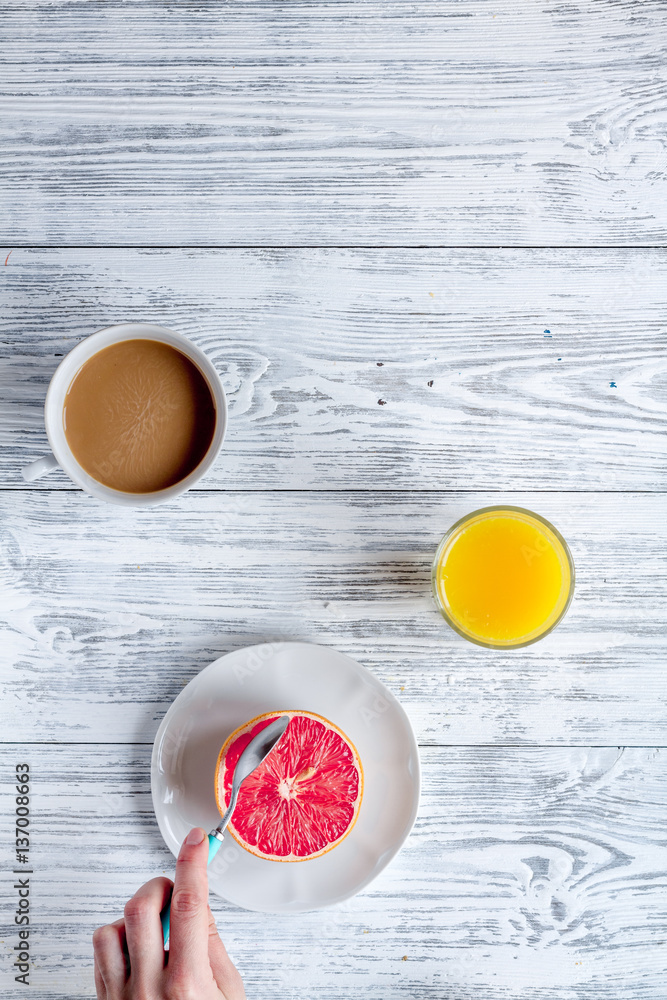 Breakfast concept with flowers on wooden background top view