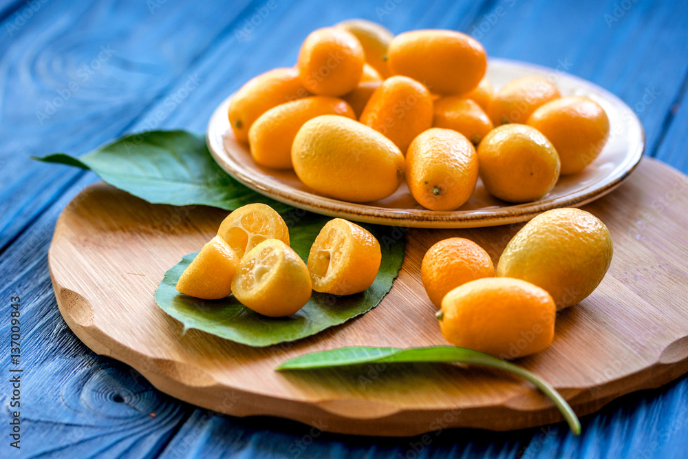 kumquat on plate at wooden table