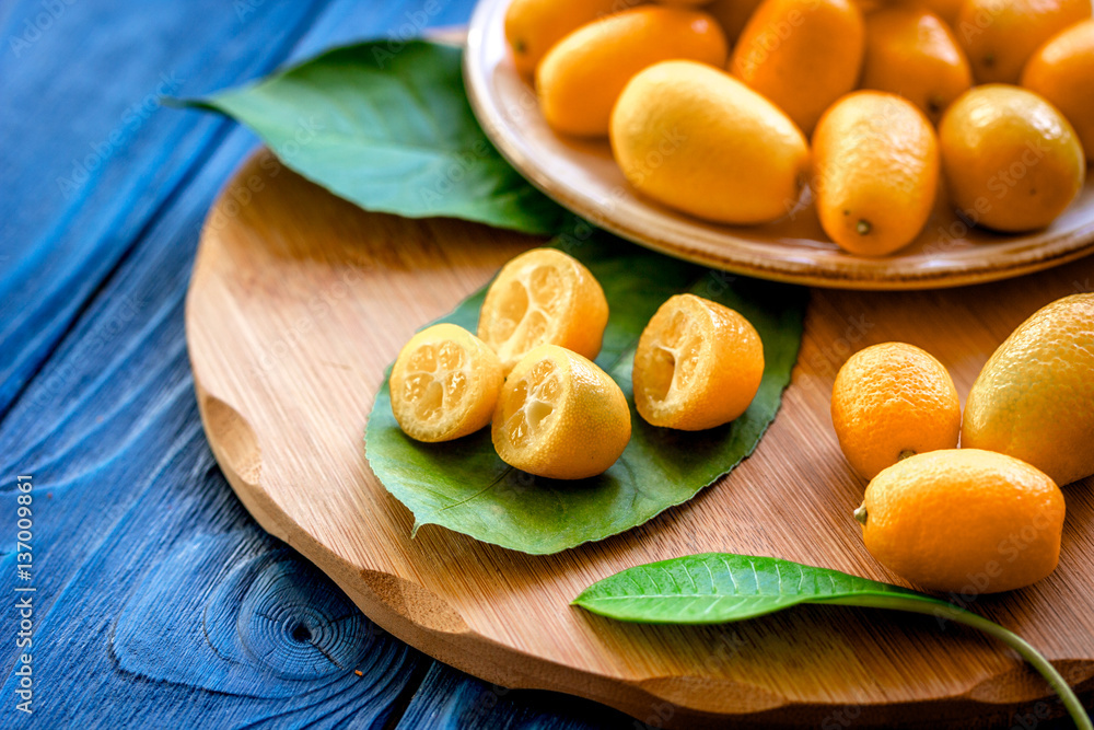 kumquat on plate at wooden table