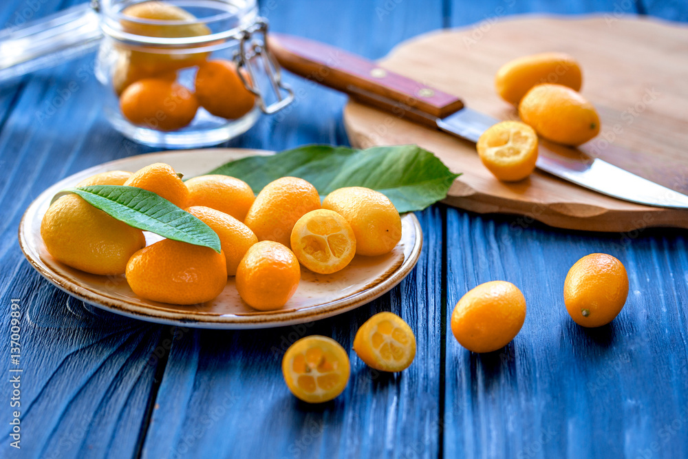 kumquat on plate at wooden table