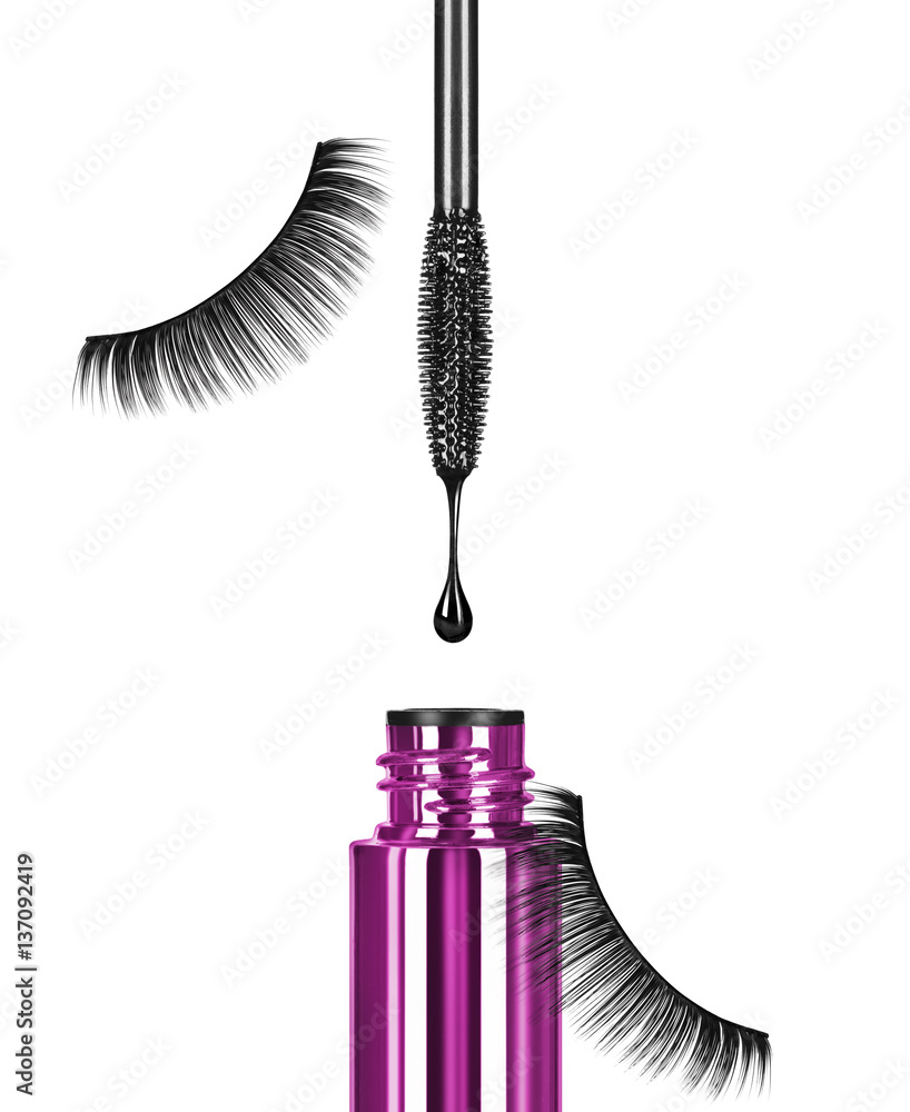 Close-up of black mascara brush with drop and false eyelashes on white background