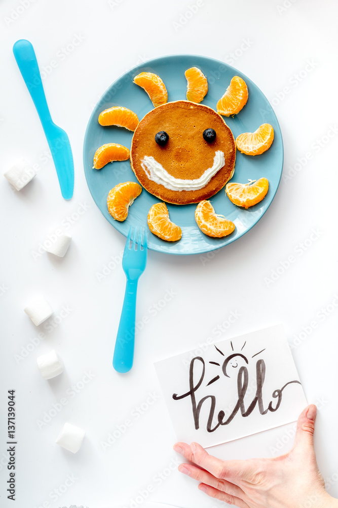 concept kid breakfast with pancake top view on white background