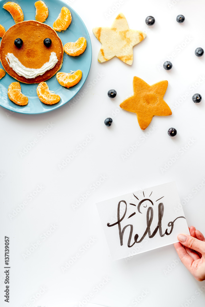 concept kid breakfast with pancake top view on white background