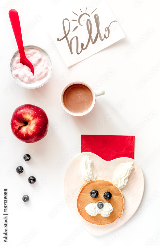 concept kid breakfast with pancake top view on white background