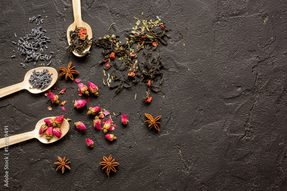 Herbs on spoons black background mock-up top view