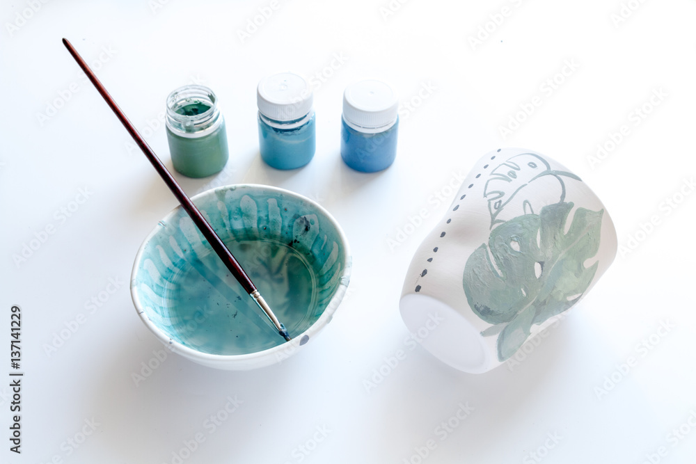 painted ceramic cup on white background