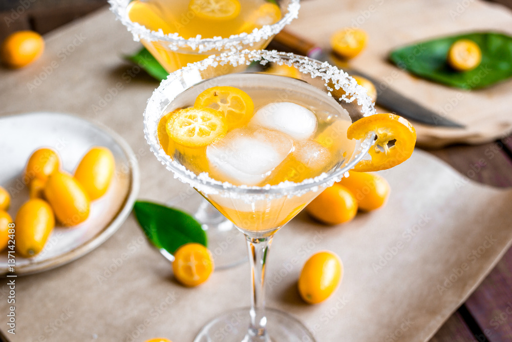 cocktail with kumquat on wooden background