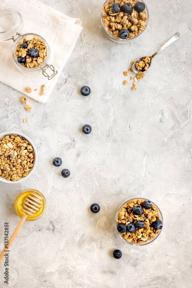 Oat flakes and berries granola glass on table background top view