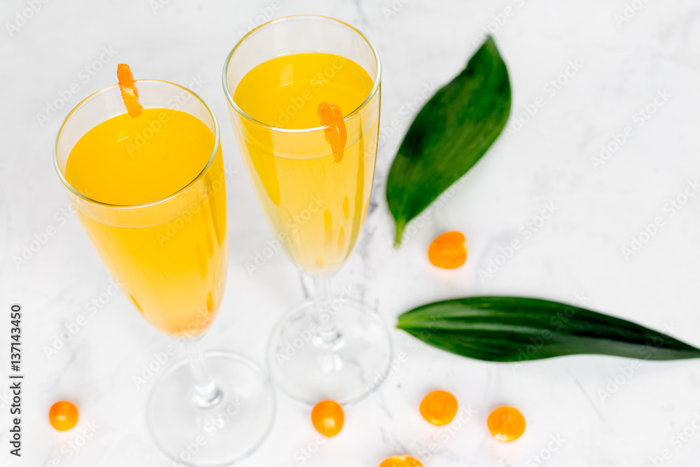 cocktail with physalis in glass on stone background