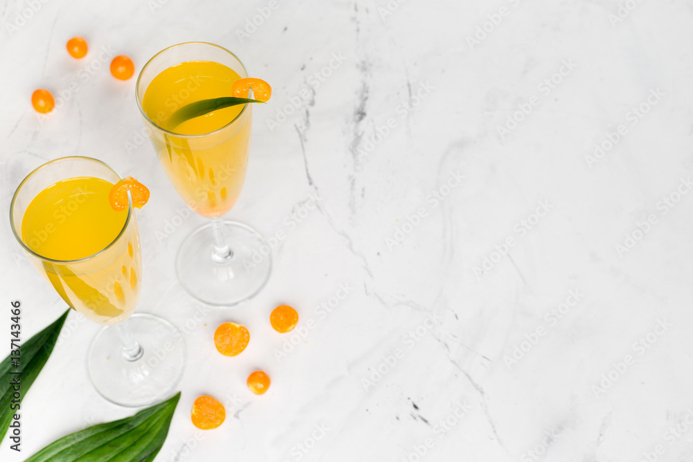 cocktail with physalis in glass on stone background