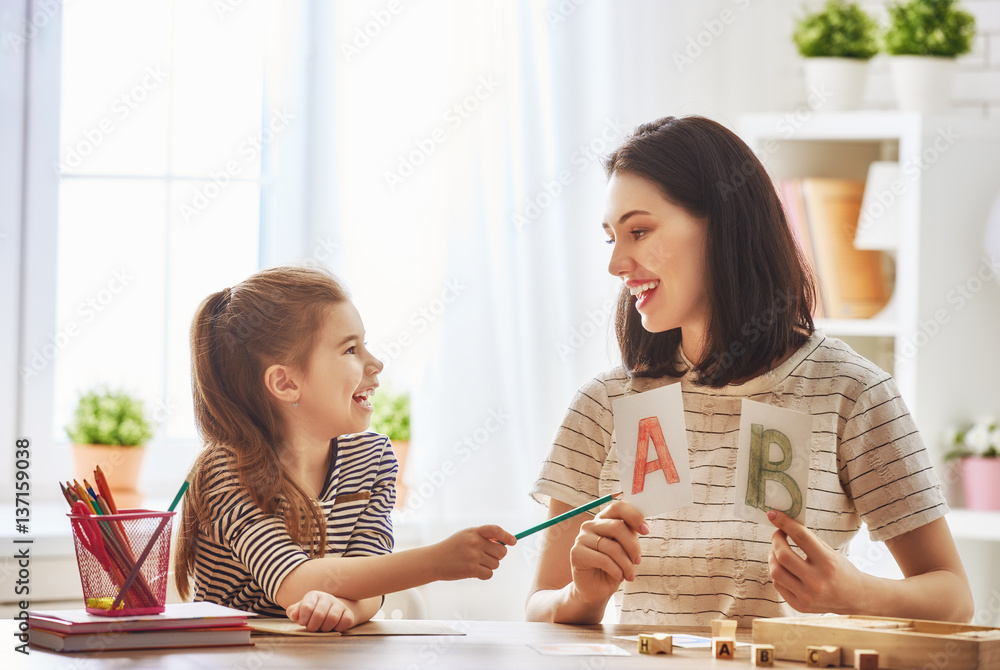 woman teaches child the alphabet