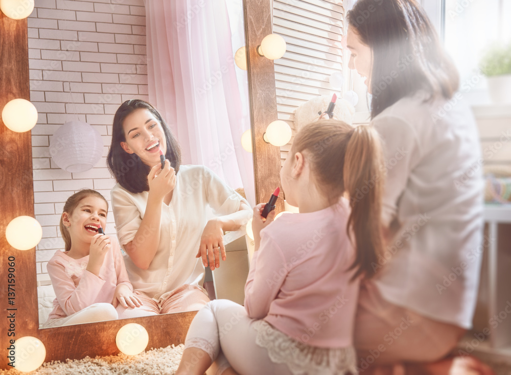 Mom and daughter wear lipstick