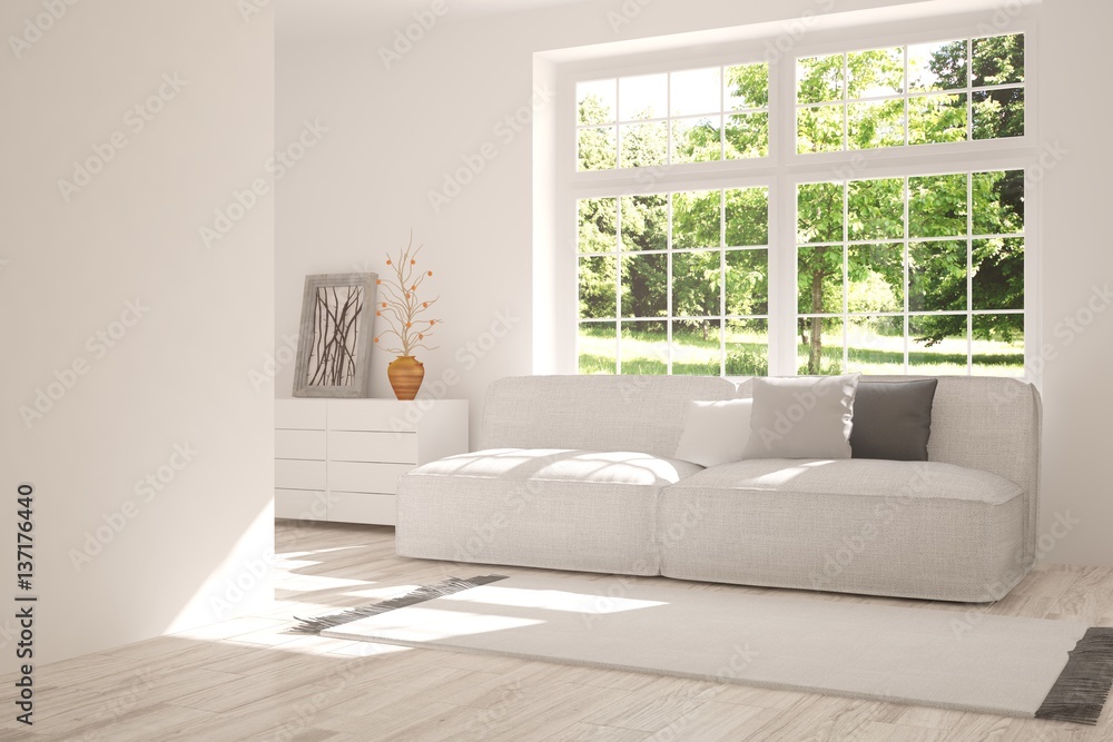 White room with sofa and green landscape in window. Scandinavian interior design