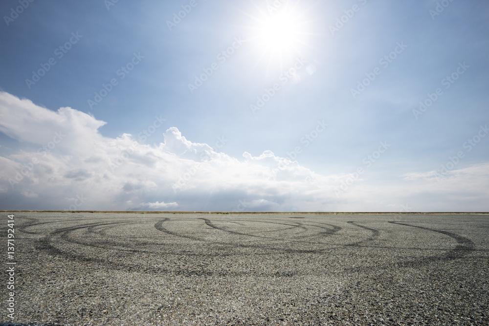 empty asphalt road in blue sunny sky